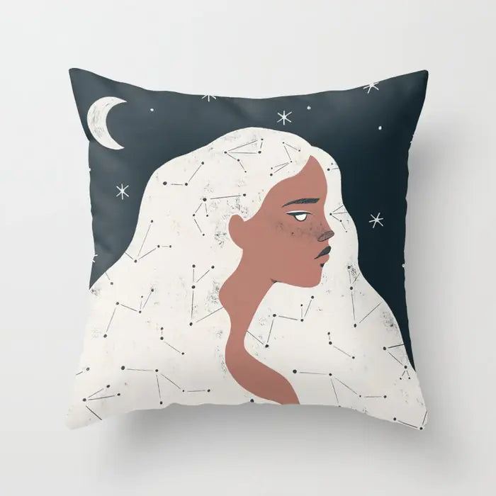 Decorative pillow with an illustration of a woman's face and constellation design on a dark blue background.