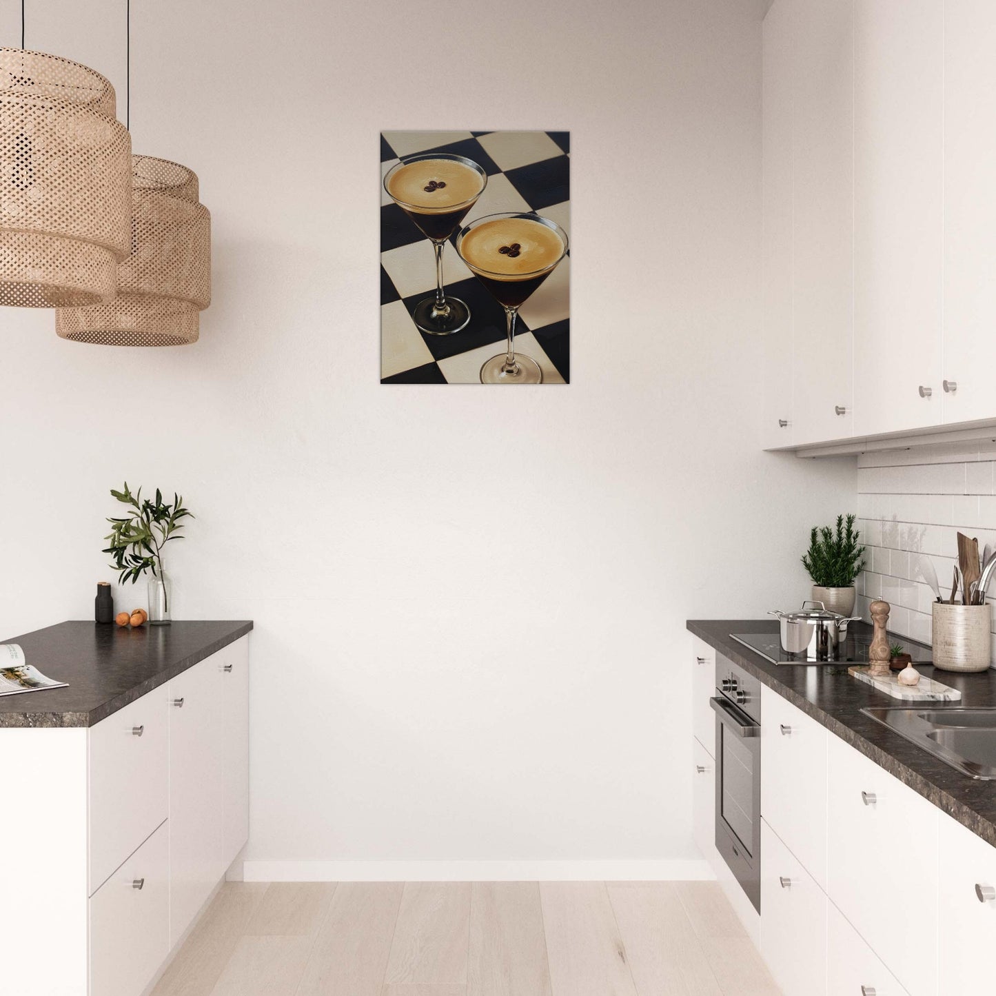 A canvas wall art print depicting two cocktails on a black-and-white checkered surface, displayed in a modern white kitchen above a countertop.