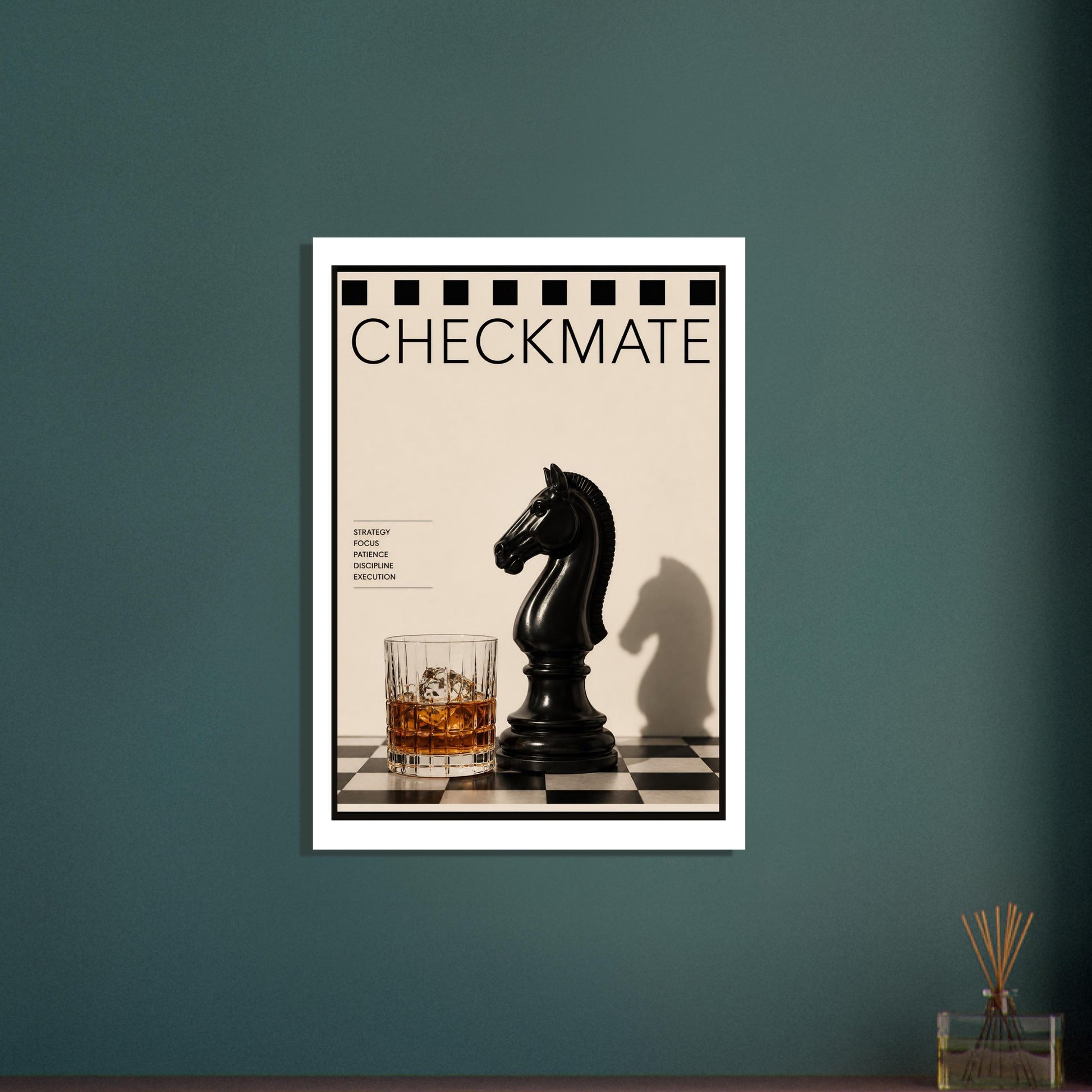 Framed artwork titled 'Checkmate' with a black chess piece and glass of whiskey on a checkered surface against a teal wall.