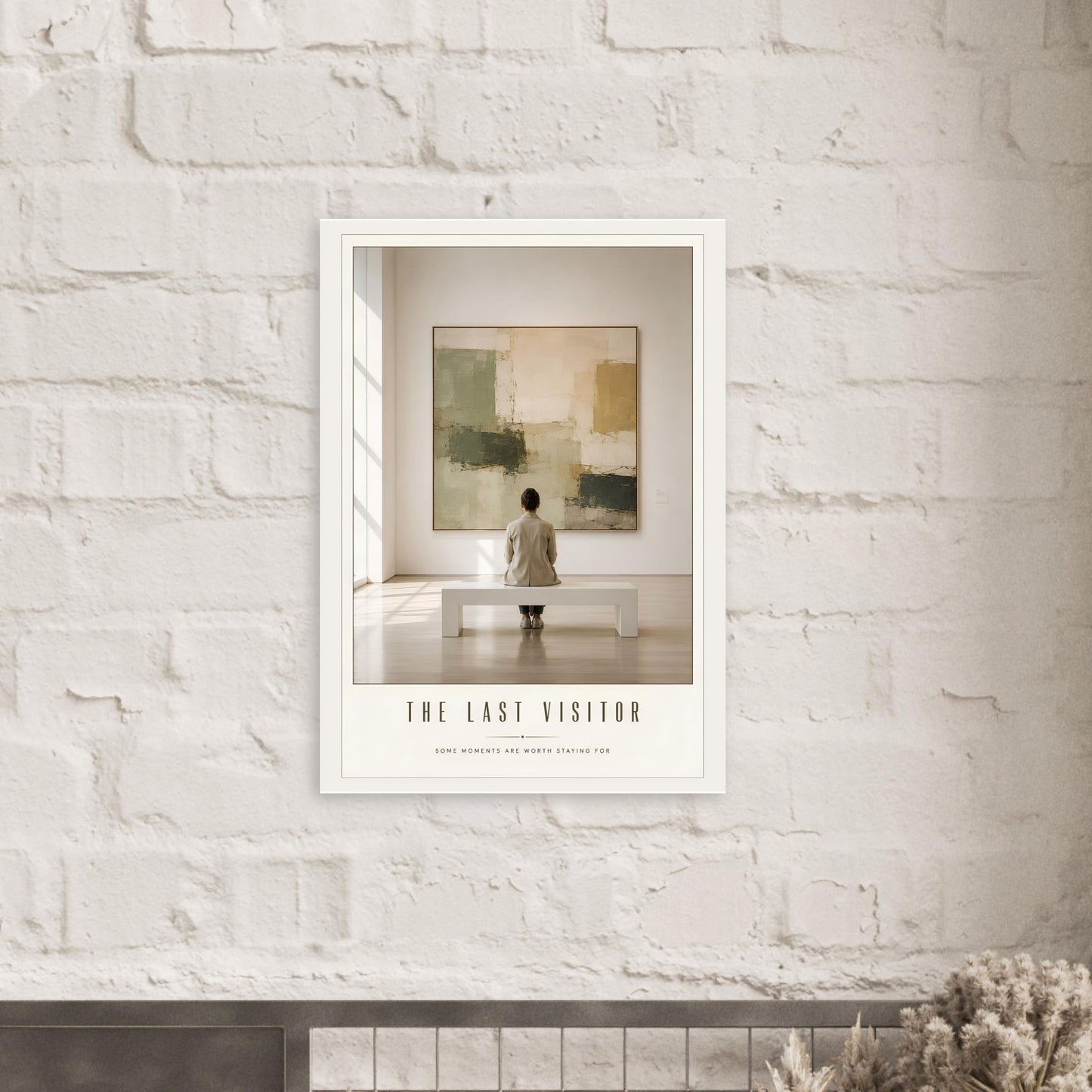 Framed artwork on a white brick wall with text 'The Last Visitor'.
