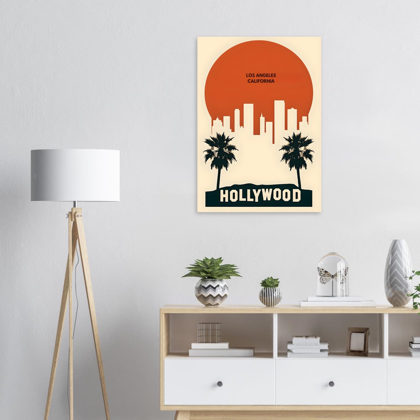 Hollywood-themed wall art above a white console table with decorative items.