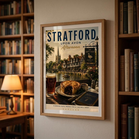 Framed poster of Stratford-upon-Avon with a drink and pie on a table, in a room with bookshelves.