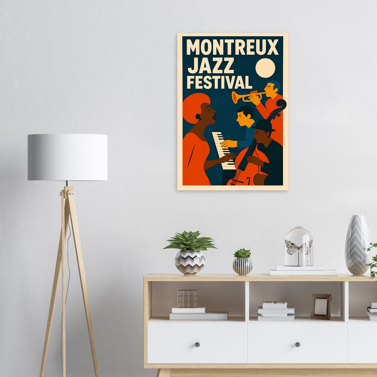 A framed poster featuring a retro-style illustration of the Montreux Jazz Festival, hung on a light gray wall above a white wooden cabinet in a modern living room setting.