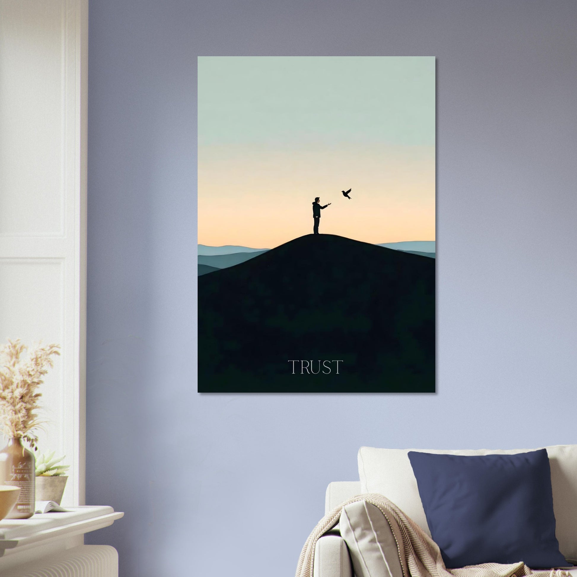 Poster of a silhouette on a hill with 'TRUST' text in a living room.
