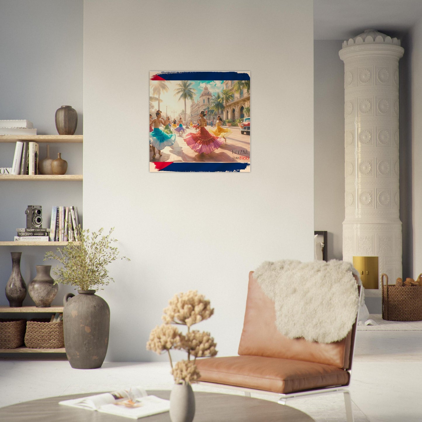 Living room with a painting of dancers in colorful outfits on a street in Havana, Cuba on the wall, a brown leather chair, and a shelf with books and decor.