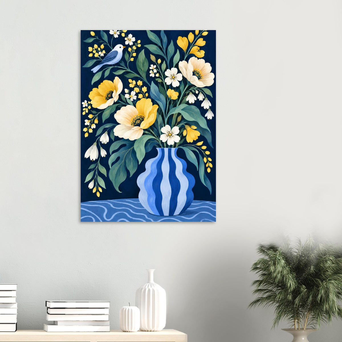 A vertical wall art print featuring a floral bouquet in a blue striped vase, hung on a light gray wall above a small table with books and decor.