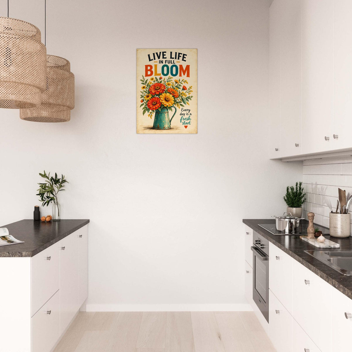 A metal wall art print with the text 'LIVE LIFE AND BLOOM' above a colorful bouquet illustration, displayed in a modern white kitchen with dark countertops.