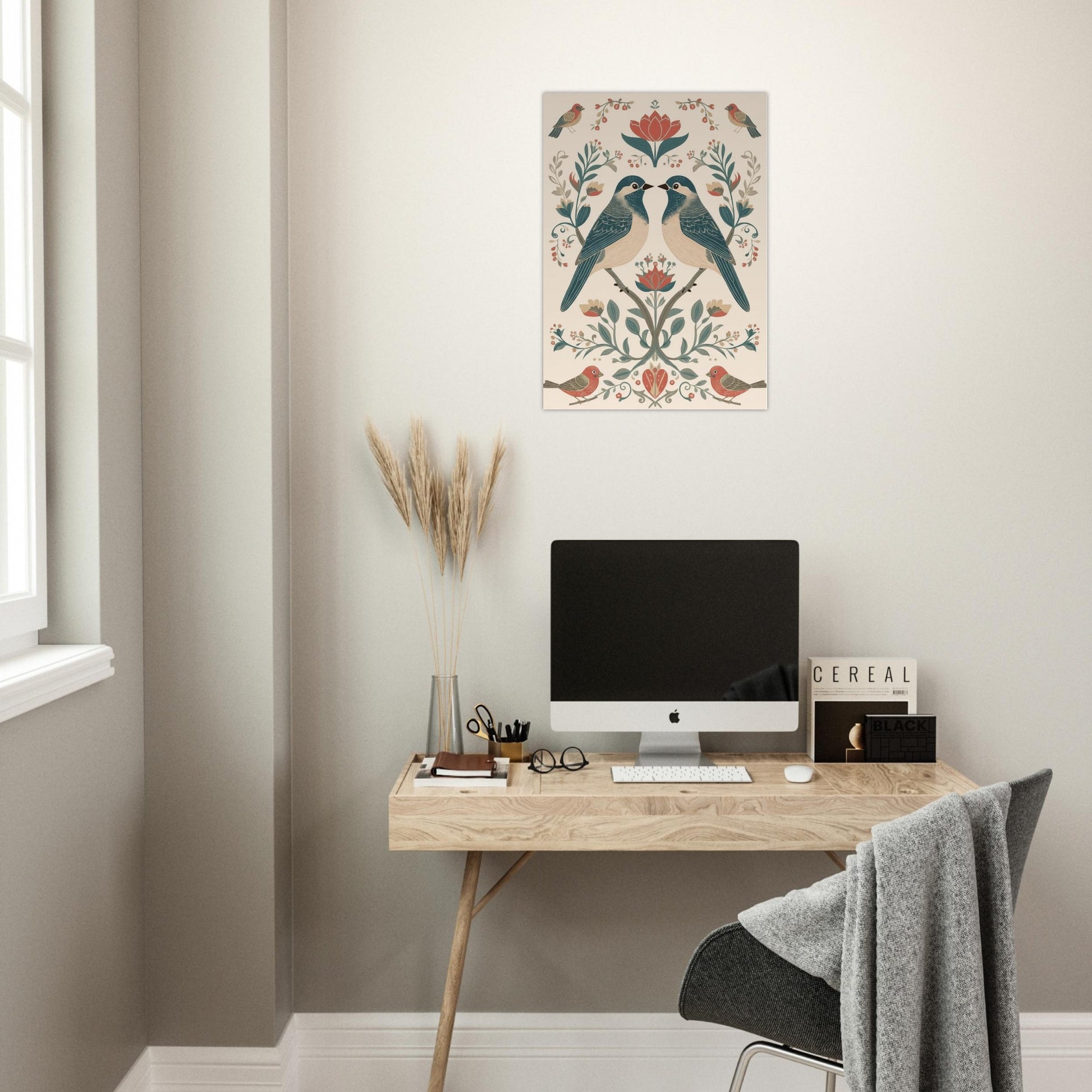 Symmetrical bird and floral poster displayed in home office workspace with clean white interior