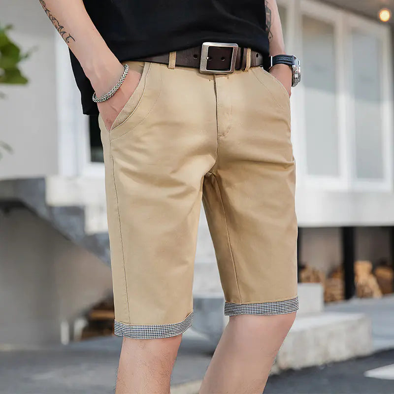 A pair of beige men's casual sports shorts with a mid-waist fit and adjustable drawstring closure, worn by a model.