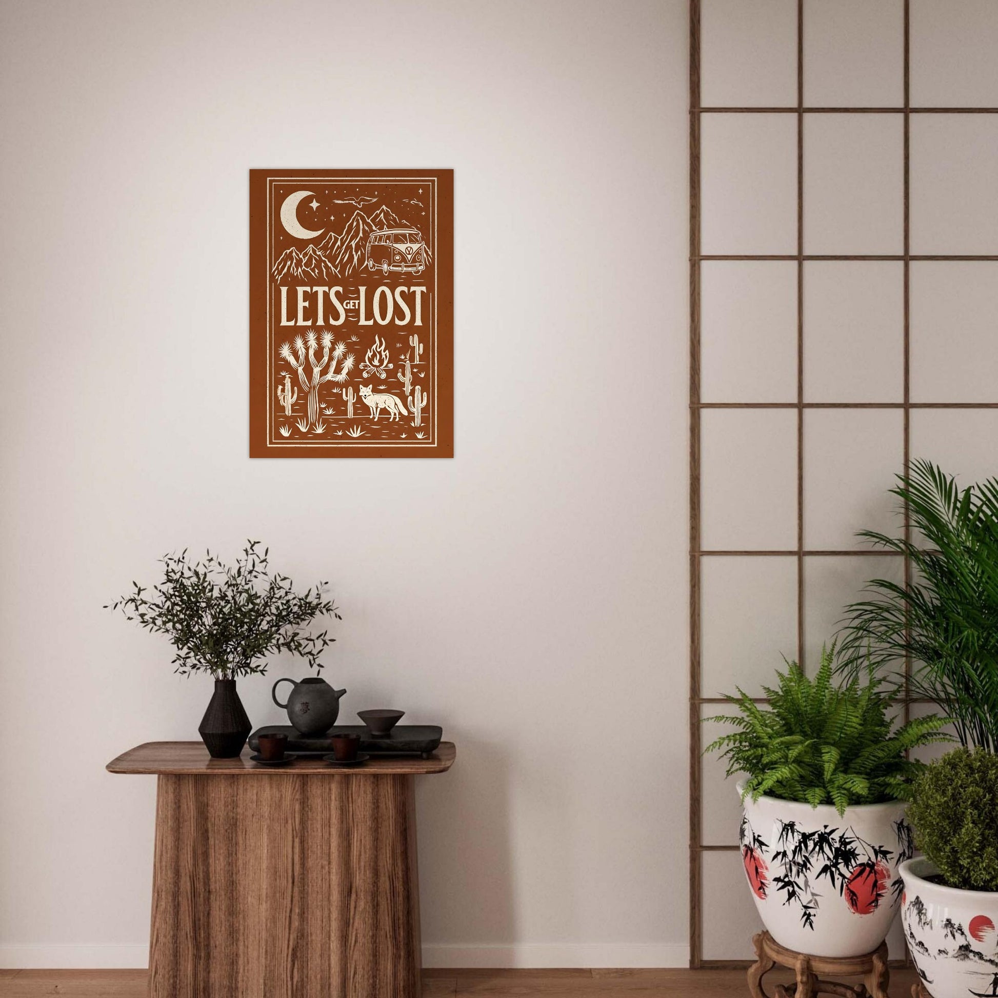 Decorative wall art with 'Let's Get Lost' text in a stylized design on a white wall.