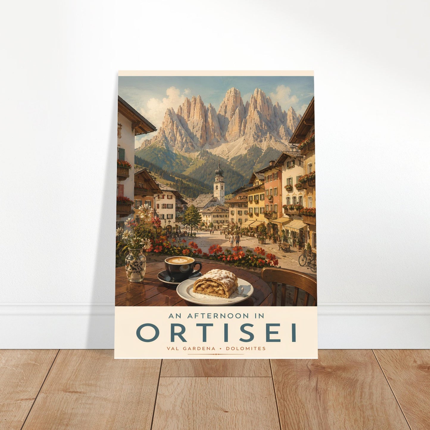 Ortisei travel poster displayed in a bright modern room with wooden flooring, showcasing the colourful alpine village and dramatic Dolomite mountain scenery.