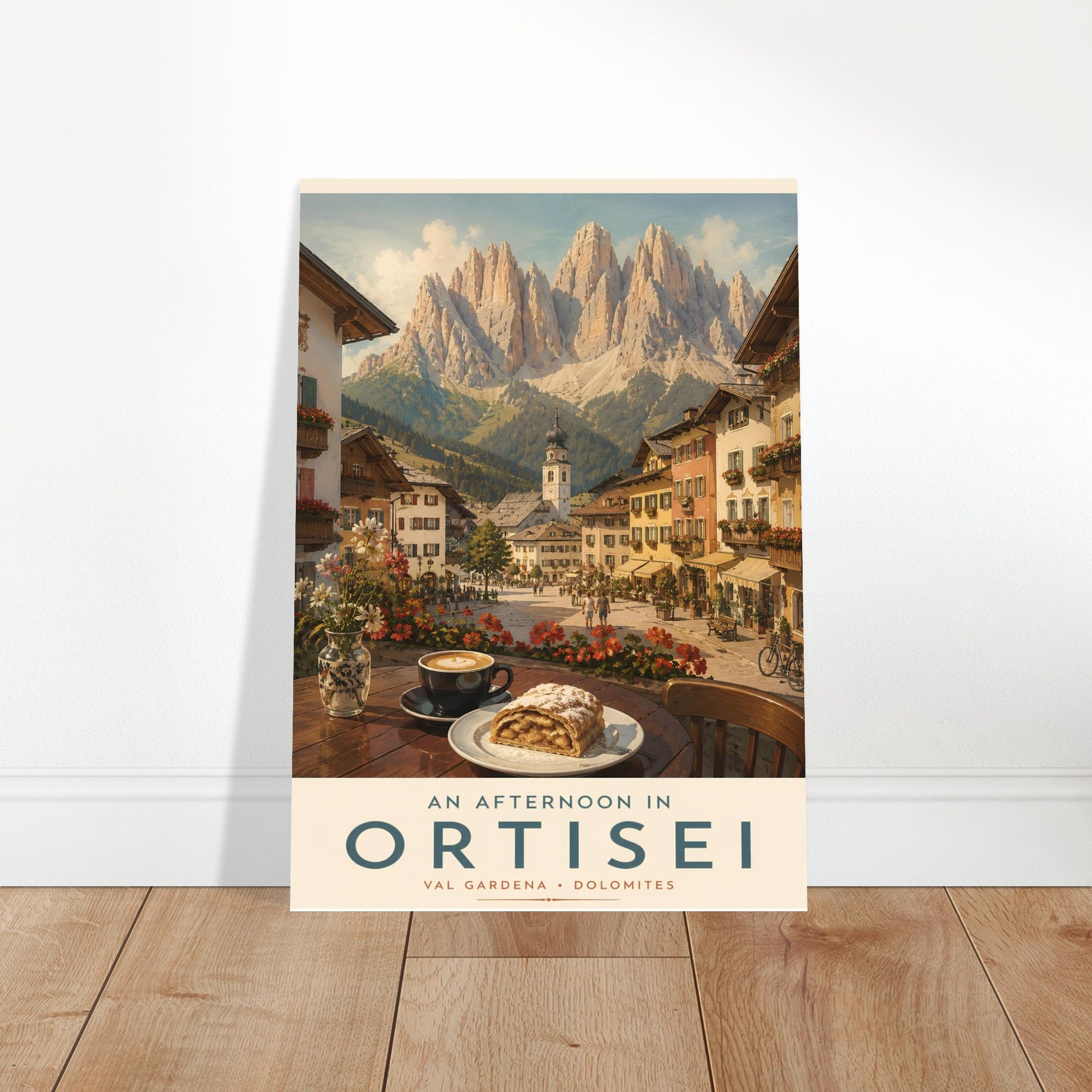 Ortisei travel poster displayed in a bright modern room with wooden flooring, showcasing the colourful alpine village and dramatic Dolomite mountain scenery.