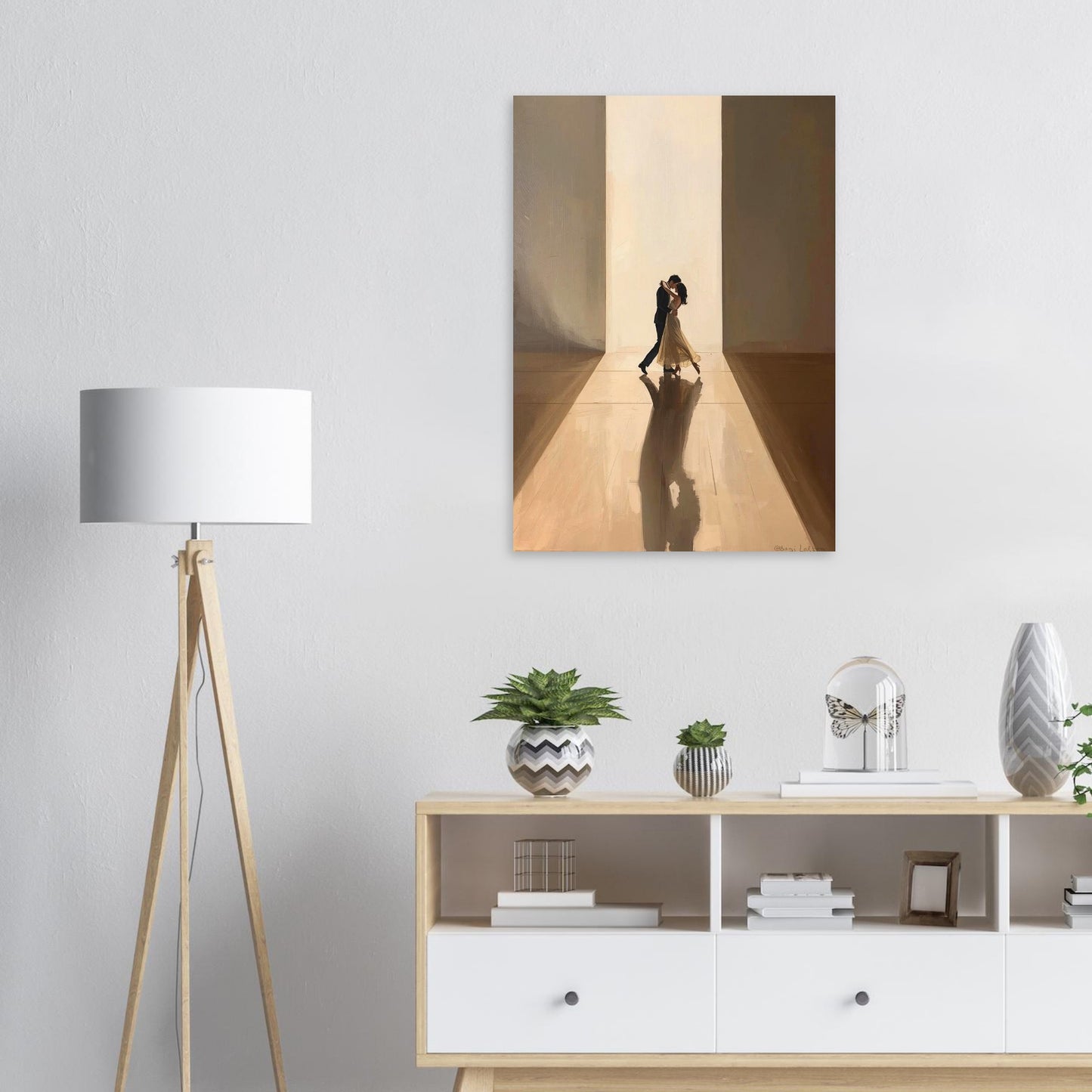 Modern interior with a lamp, cabinet, and wall art of a couple embracing.