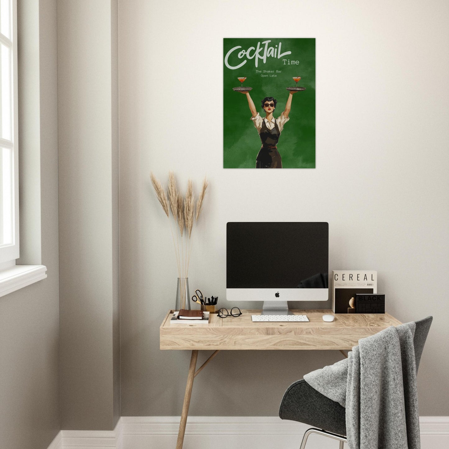 Modern home office with a desk, computer, and wall art of a woman holding cocktails.