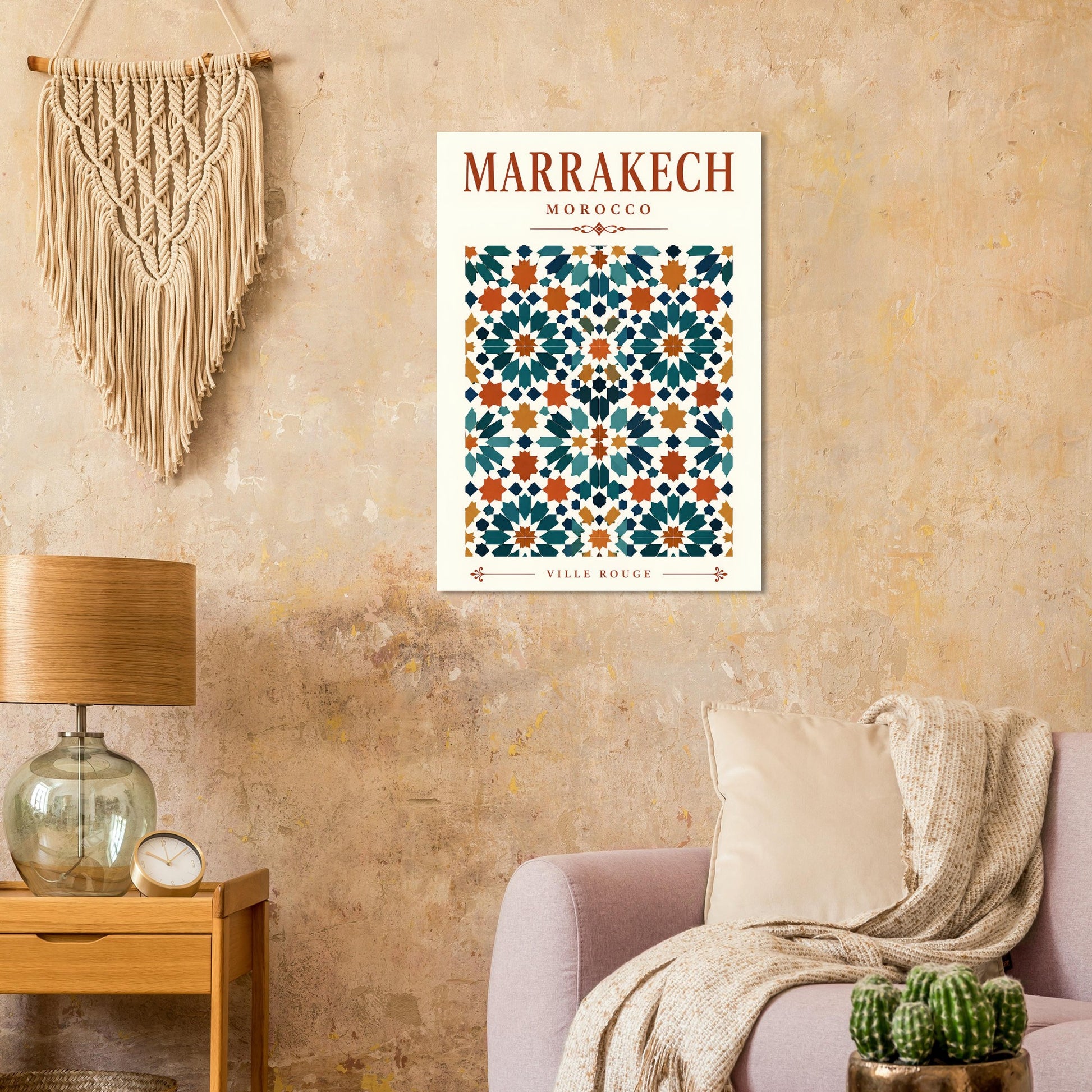 A framed art print featuring a Moroccan tile pattern with the text 'MARRAKECH MOROCCO' and 'SILEY BISHOP' is shown hanging on a textured beige wall in a styled living room setting.