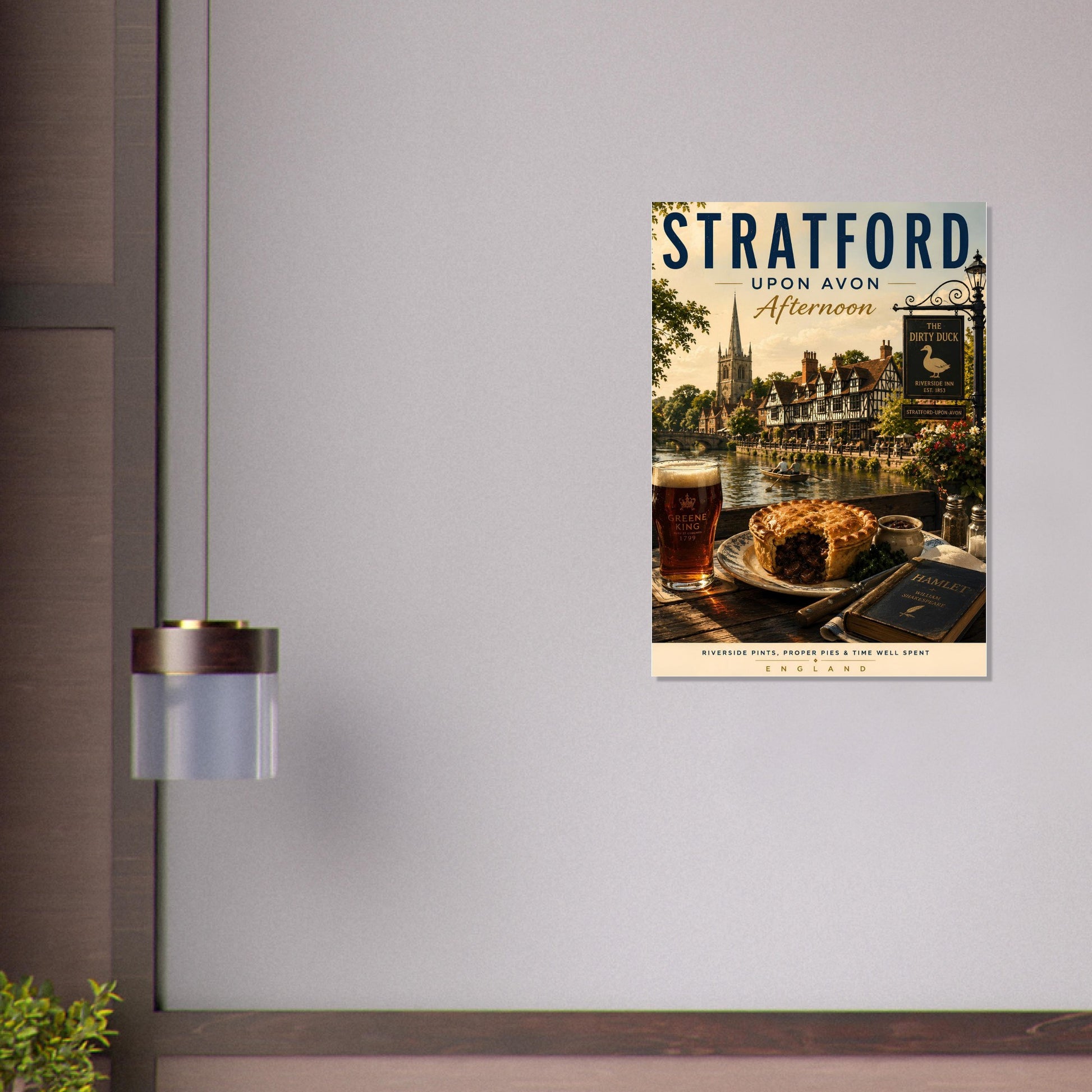 Poster of Stratford-upon-Avon with a drink and cake on a table, displayed on a wall.