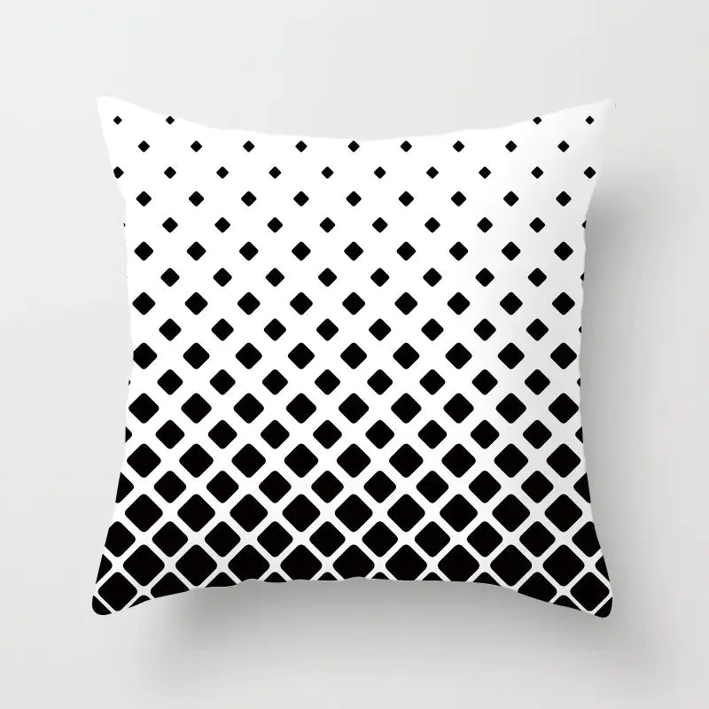 Decorative pillow with black and white geometric pattern on a light gray background