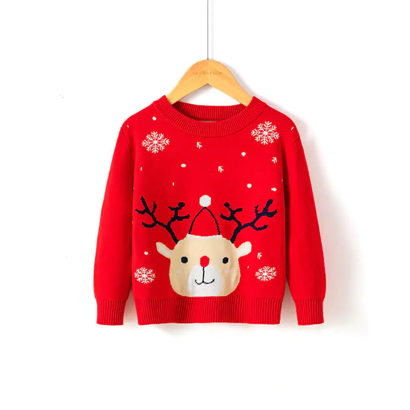 Red sweater with reindeer design on a hanger against a white background