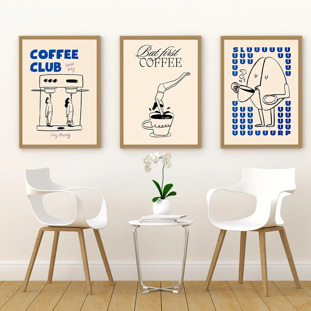 Three framed prints on a wall above a table with chairs.