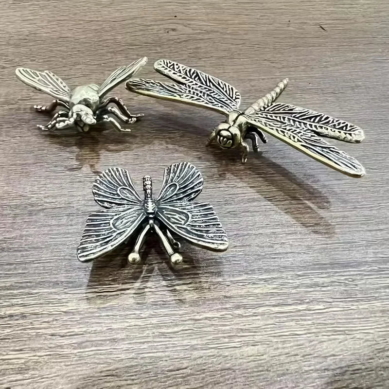 Antique brass-style dragonfly, bee and butterfly figurines with detailed textured wings, decorative set of three insect ornaments.