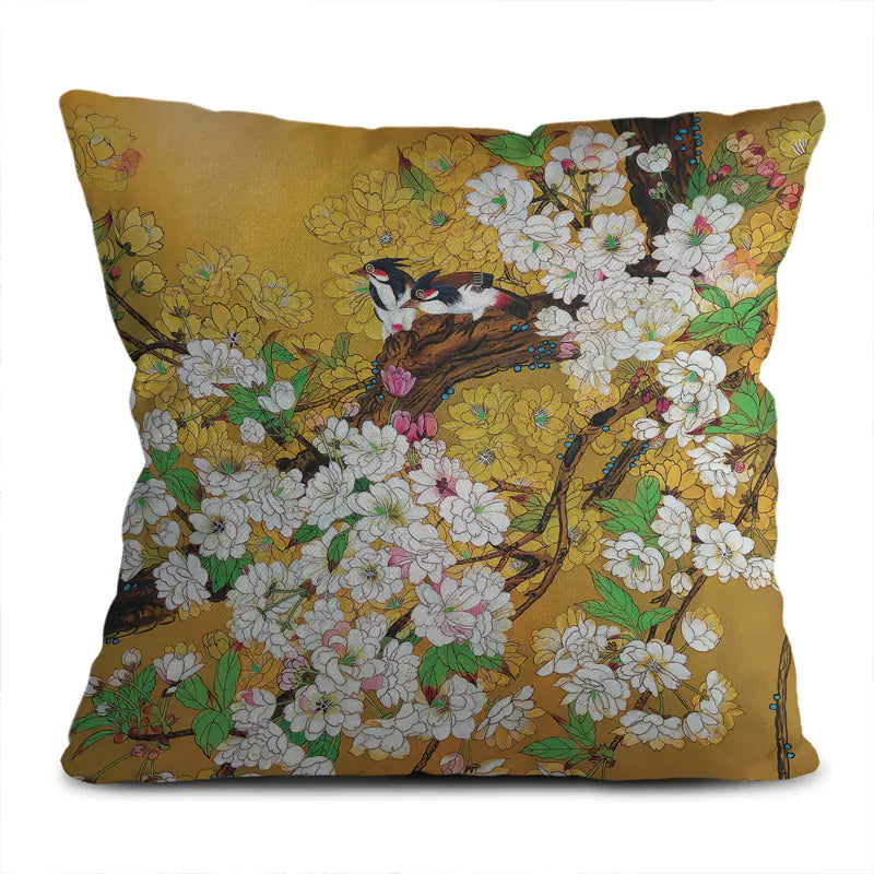 Decorative pillow with floral and bird design on a yellow background