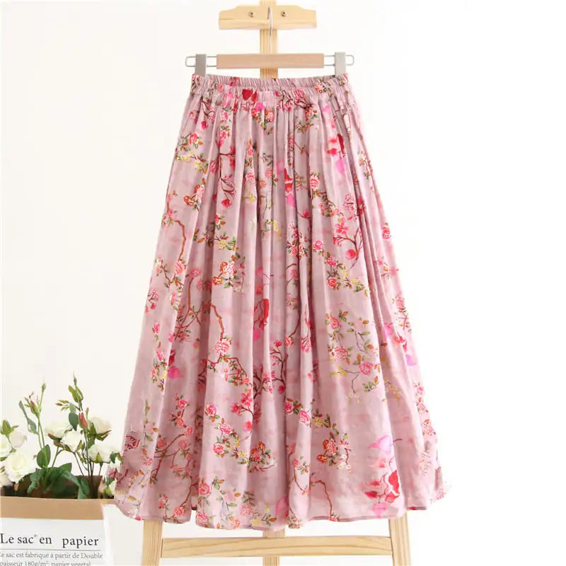 Floral patterned skirt on a wooden hanger with a white background