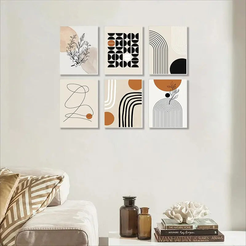 Set of six abstract art prints on a wall above a sofa.