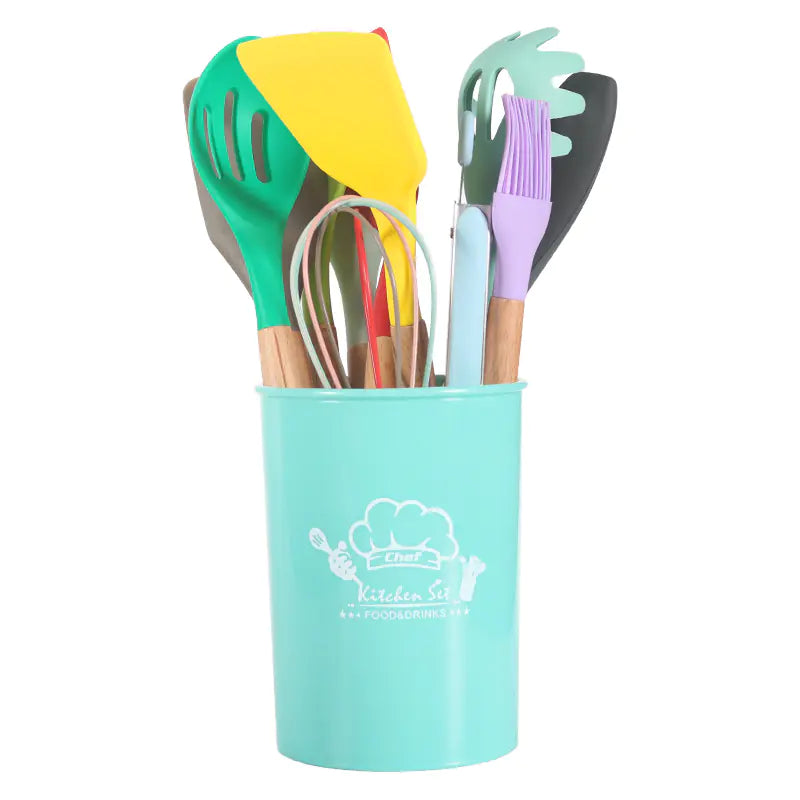 Colorful kitchen utensils in a turquoise holder on a white background