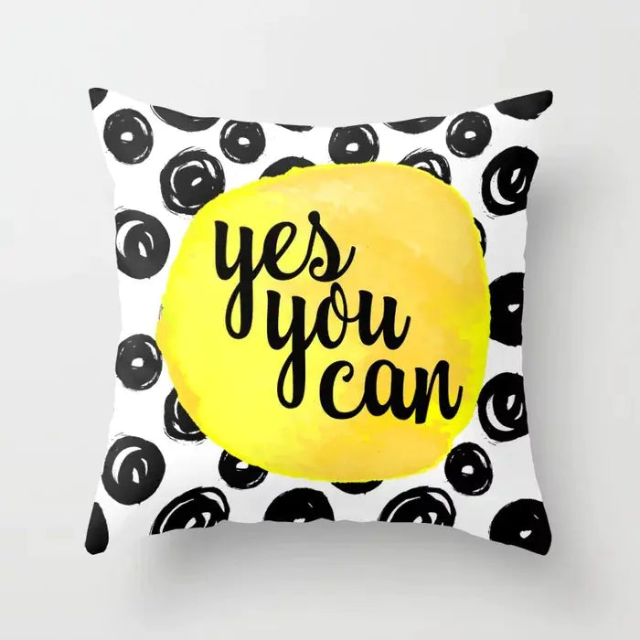 Pillow with 'yes you can' text on a white background with black circular patterns