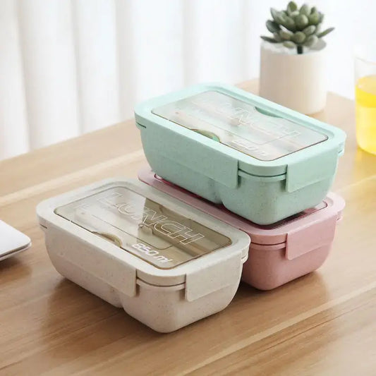 3 Eco-friendly wheat straw lunch boxes on a wooden table. 