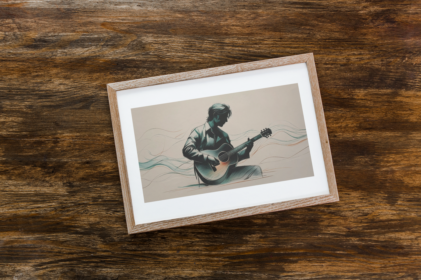 Framed artwork of a person playing guitar on a wooden surface