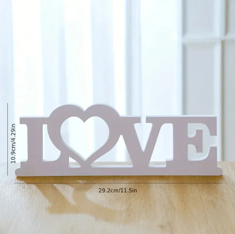 Decorative sign with ' Love' design on a wooden surface
