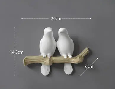 Decorative wall hook with two white birds on a branch, showing measurements.