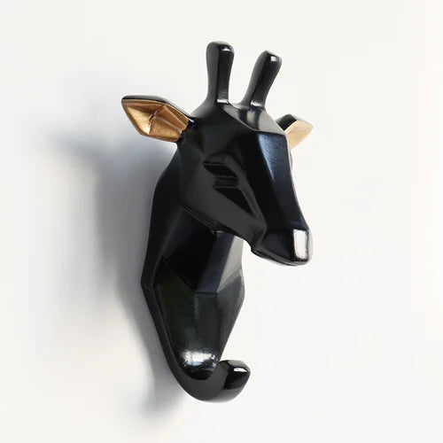 Black giraffe-shaped wall hook on a white background