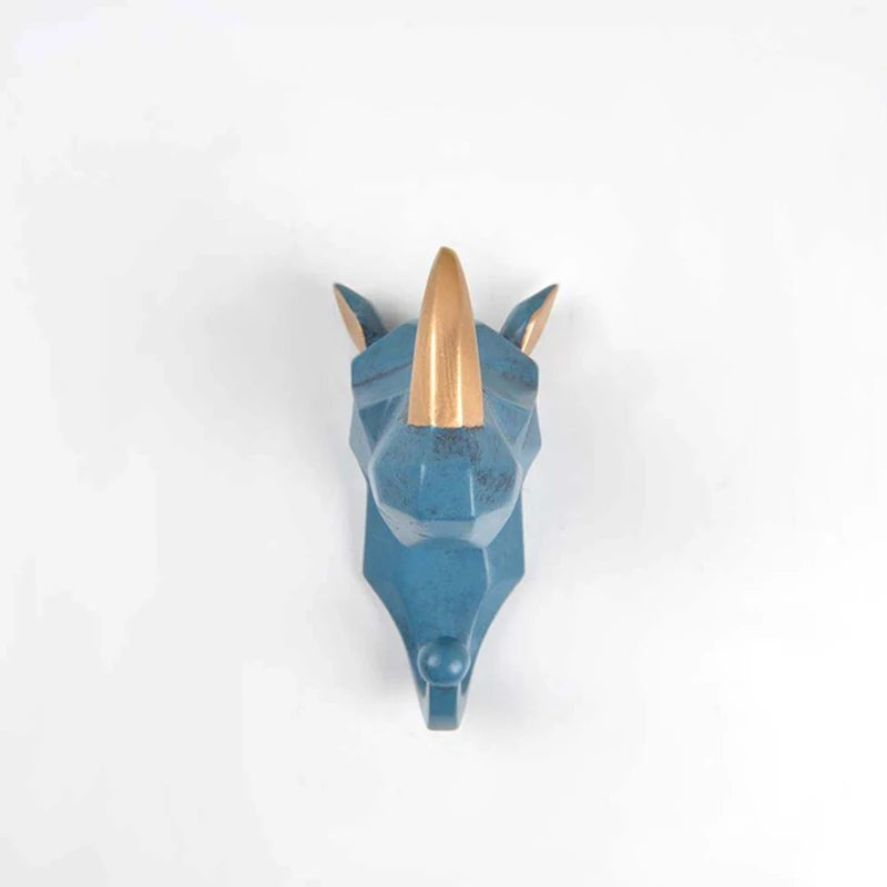 Blue animal head wall hook with gold horn on a white background