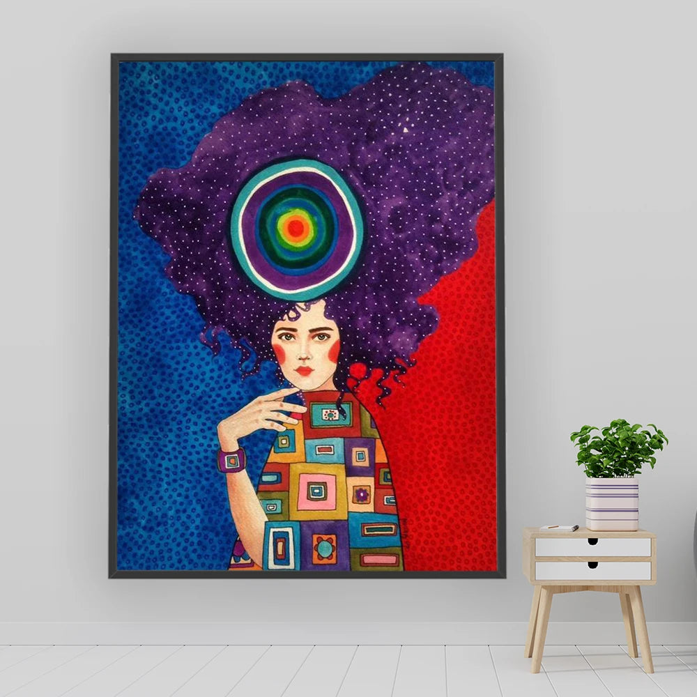 Colorful abstract art print of a woman with a vibrant afro on a white wall.