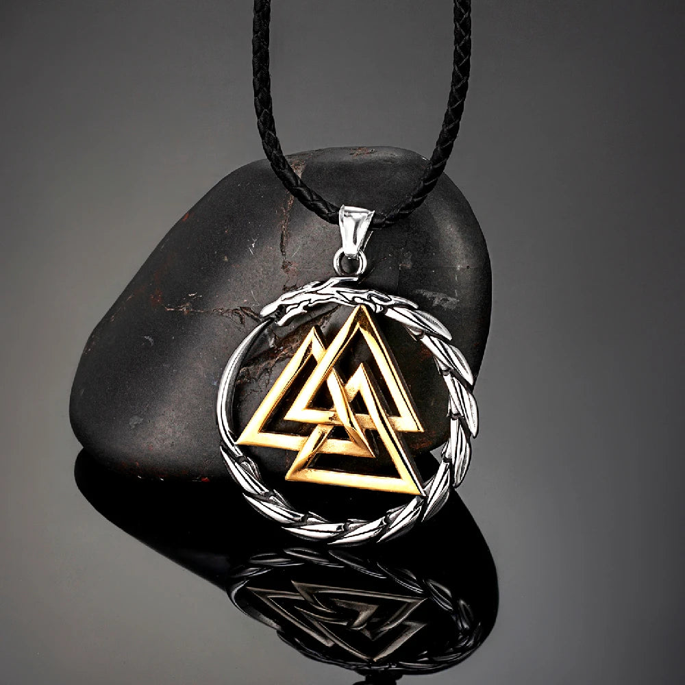 Triangular pendant with interlocking triangles on a black stone with a gray background