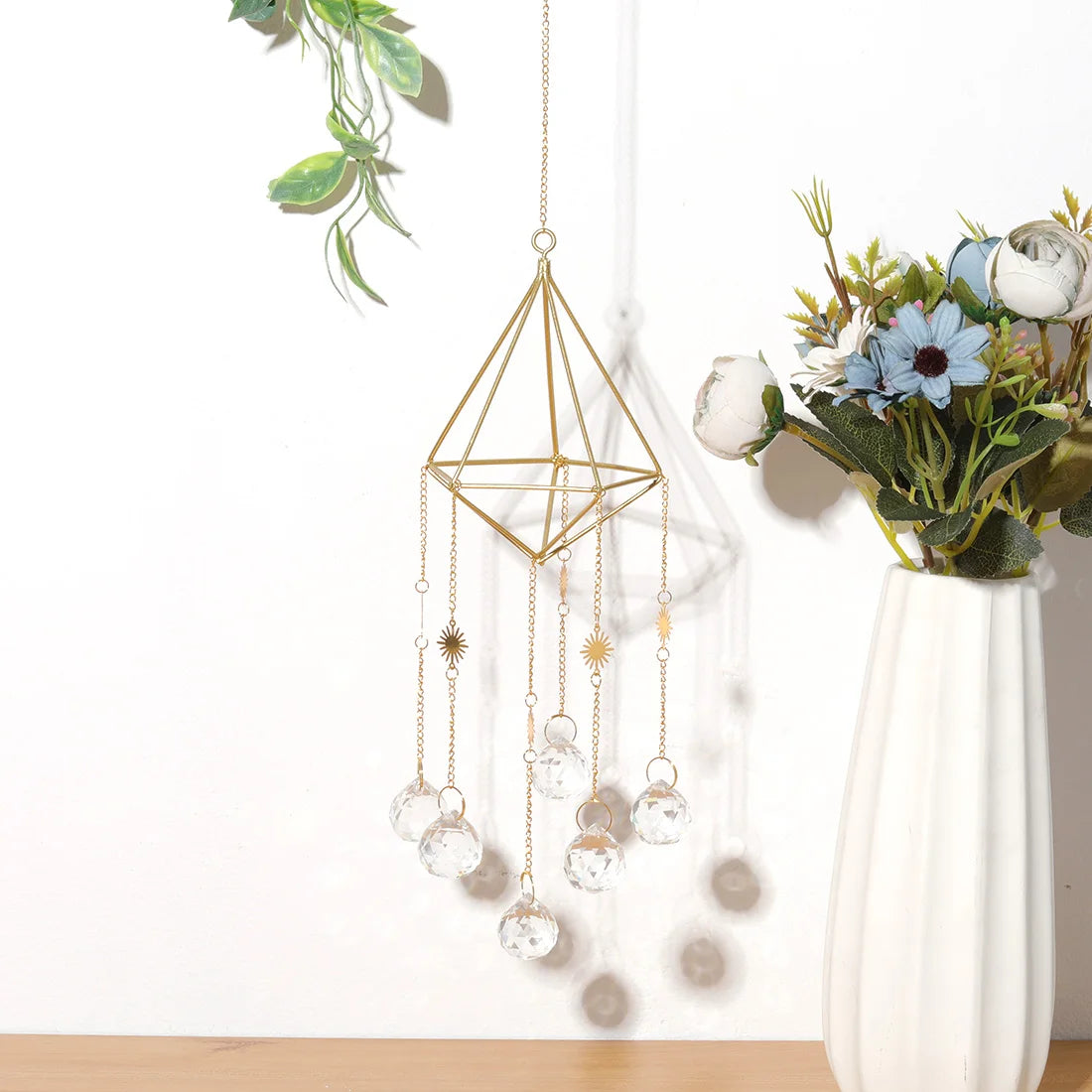 Decorative hanging crystal chime with geometric design on a white background