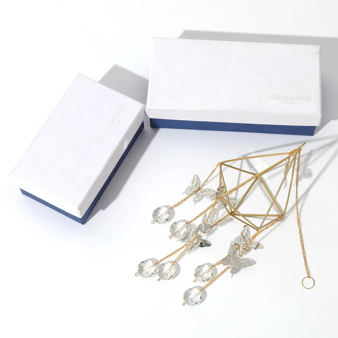 Gold and silver hairpin with butterfly design on a white background