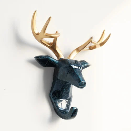 Decorative deer head with gold antlers on a white background