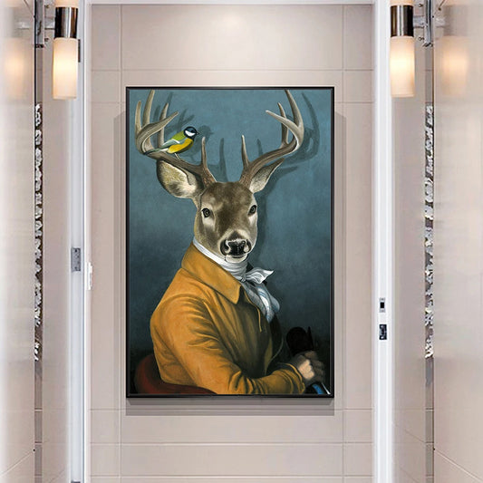 Framed artwork of a deer wearing a yellow jacket with a bird on its head, mounted on a wall.