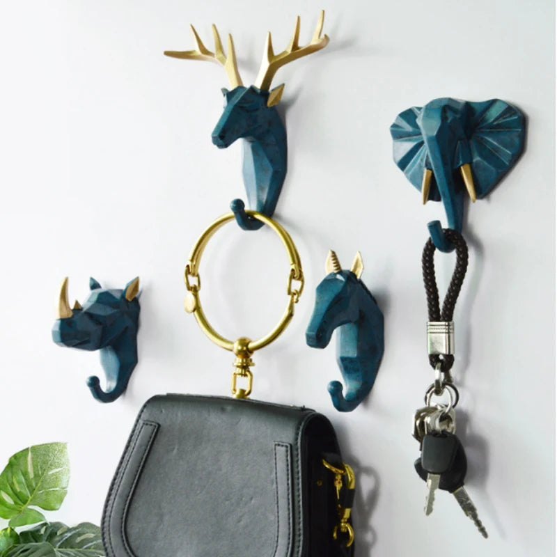 Set of decorative animal wall hooks with keys and a handbag on a white background