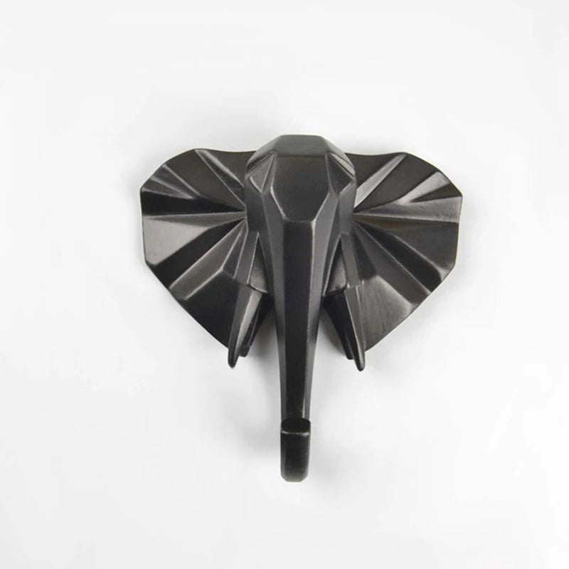 Metallic elephant head wall hook on a white background