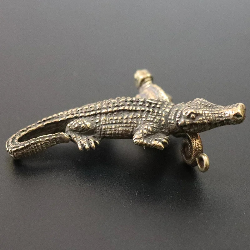 Bronze alligator figurine on a black background