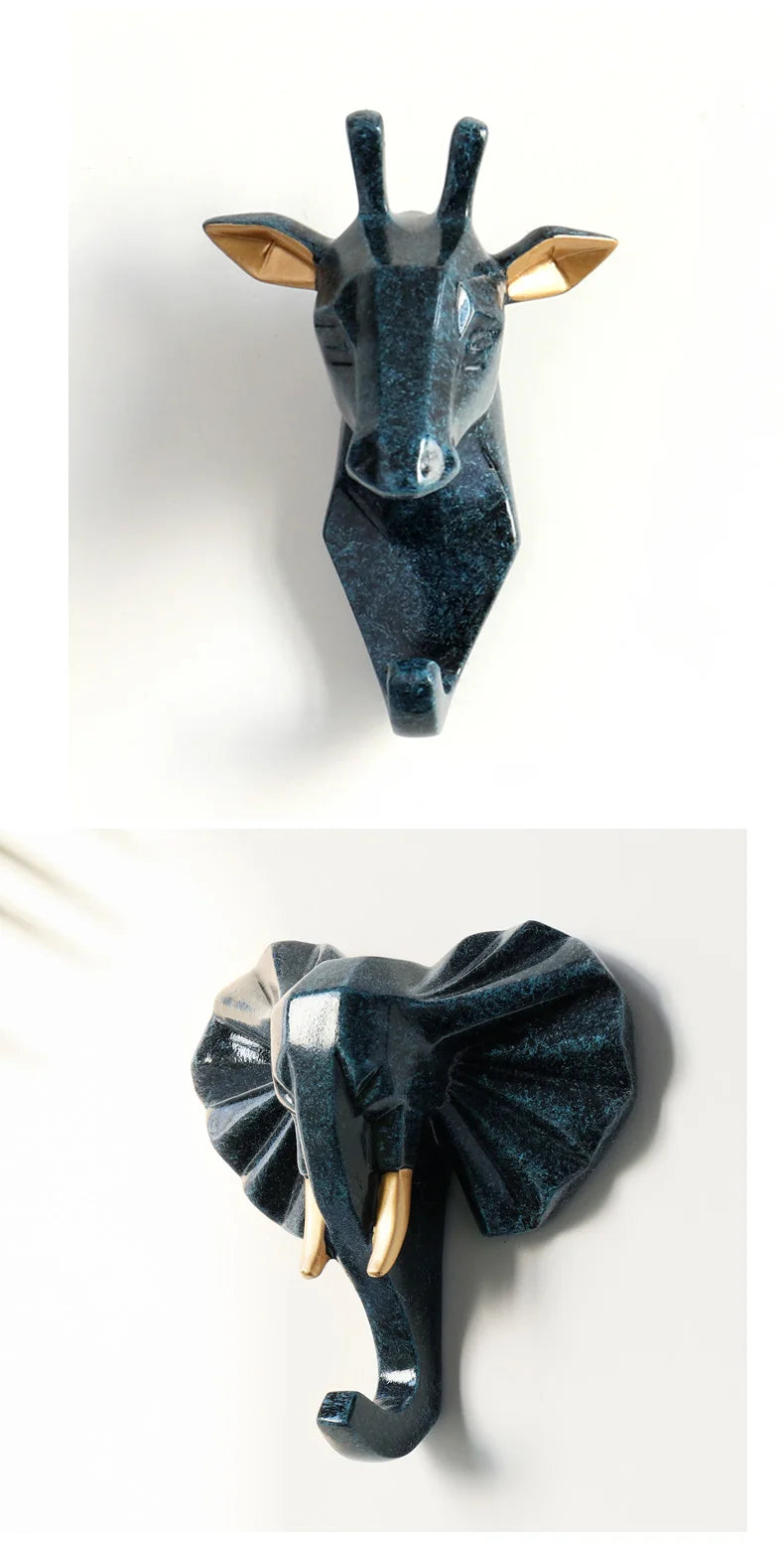 Decorative wall hooks shaped like a giraffe and an elephant on a white background