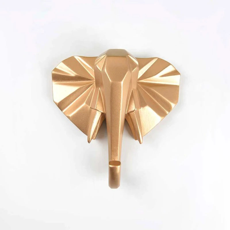 Gold elephant-shaped wall hook on a white background