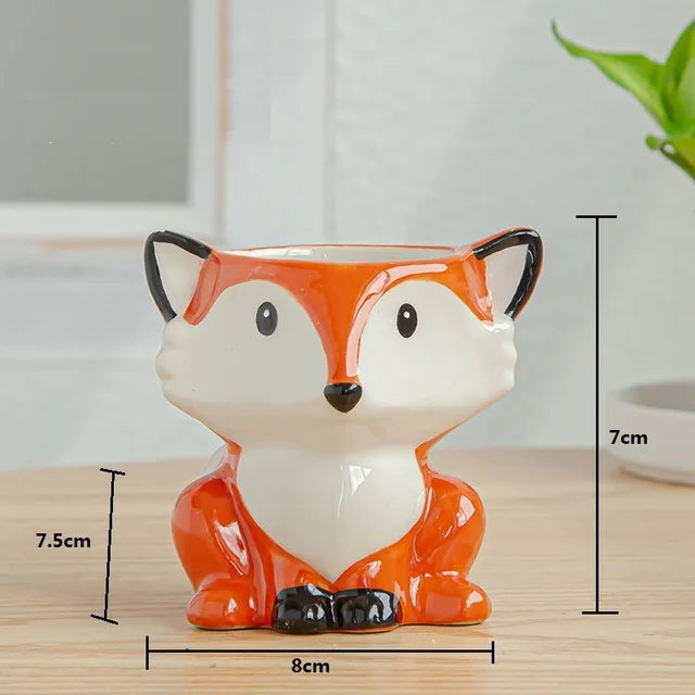 Fox-shaped planter with measurements on a wooden surface