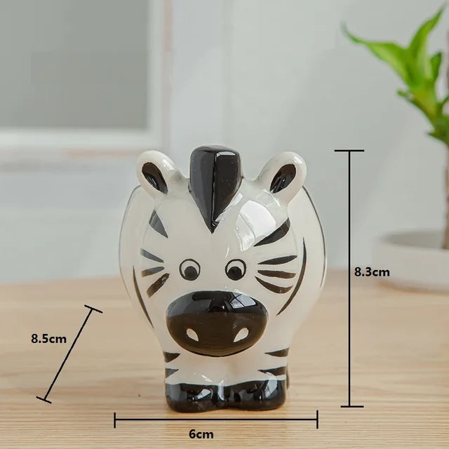 Zebra-shaped ceramic item with measurements on a wooden surface
