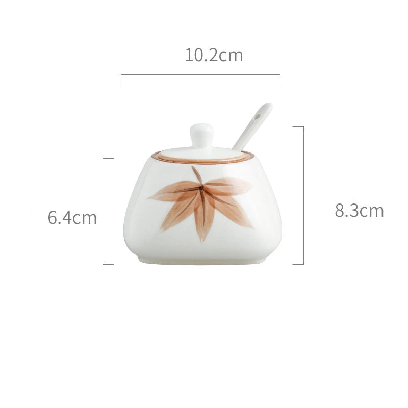 White ceramic container with leaf design and spoon, showing dimensions on a white background