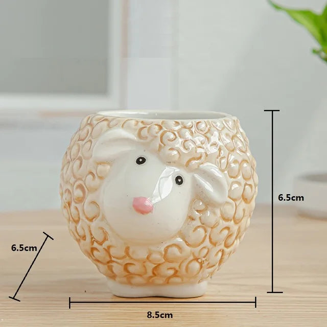 Ceramic mouse-shaped planter with measurements on a wooden surface